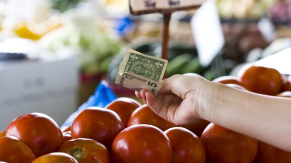 cash being exchanged at a farmers market