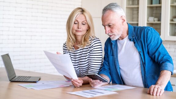 Senior couple on laptop navigating Medicare changes in 2027