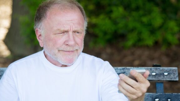 Man annoyed at phone because of friends' unrealistic requests