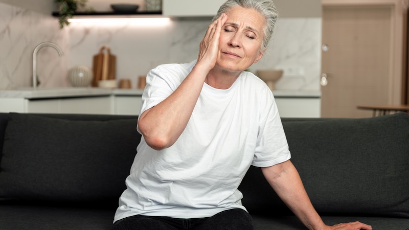 A dizzy woman on the sofa. Brizmaker. Dizziness can be a sign of epilepsy in older adults