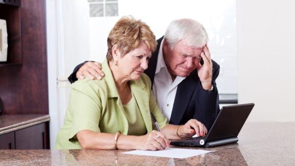 A couple looking at a computer, worried about the 2027 Social Security COLA. Michael Zhang