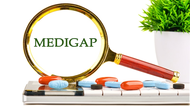 A magnifying glass showing "Medigap" and a variety of pills underneath.