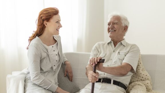 Senior man and his daughter considering the cost of senior living in Texas. Bialasiewicz